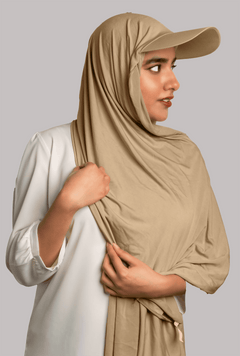 Girl wearing stylish hat hijab in light khaki color. looking left.