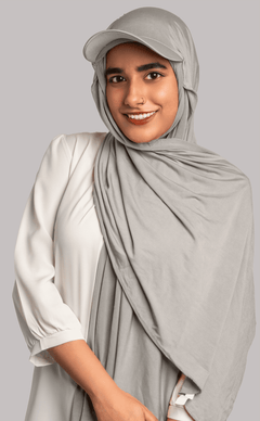 Girl Wearing Stylish Hat Hijab in grey color. looking front.