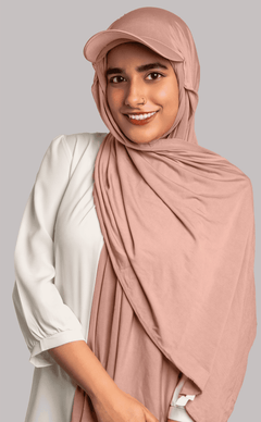 Girl Wearing Stylish Hat Hijab in meat pink color. looking front.