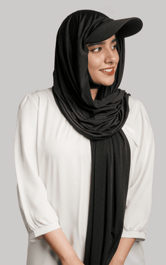 A women wearing a stylish Hat Hijab in black color and a white top looking to her left