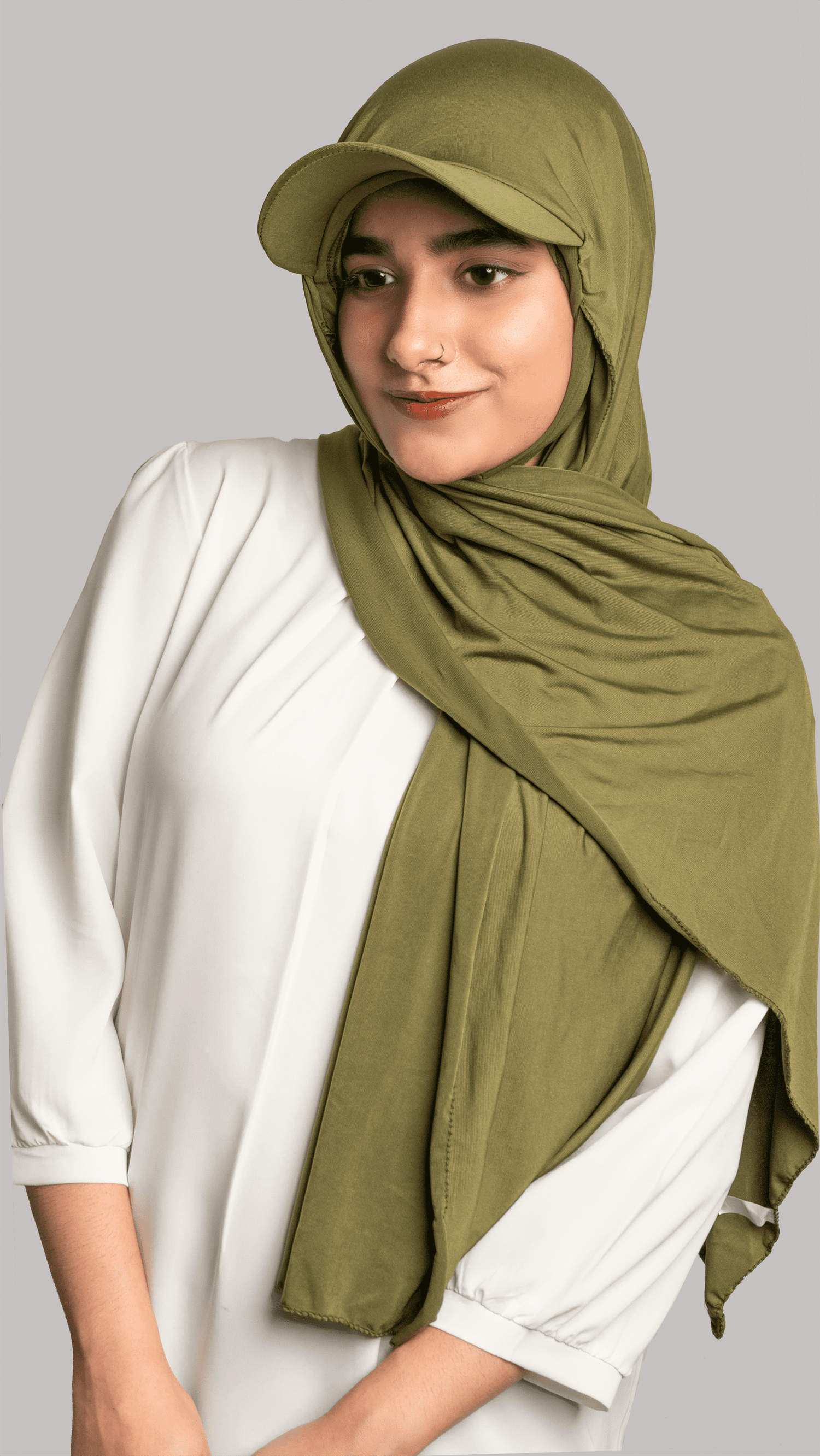 A woman wearing a stylish Hat Hijab in olive green on a white top.