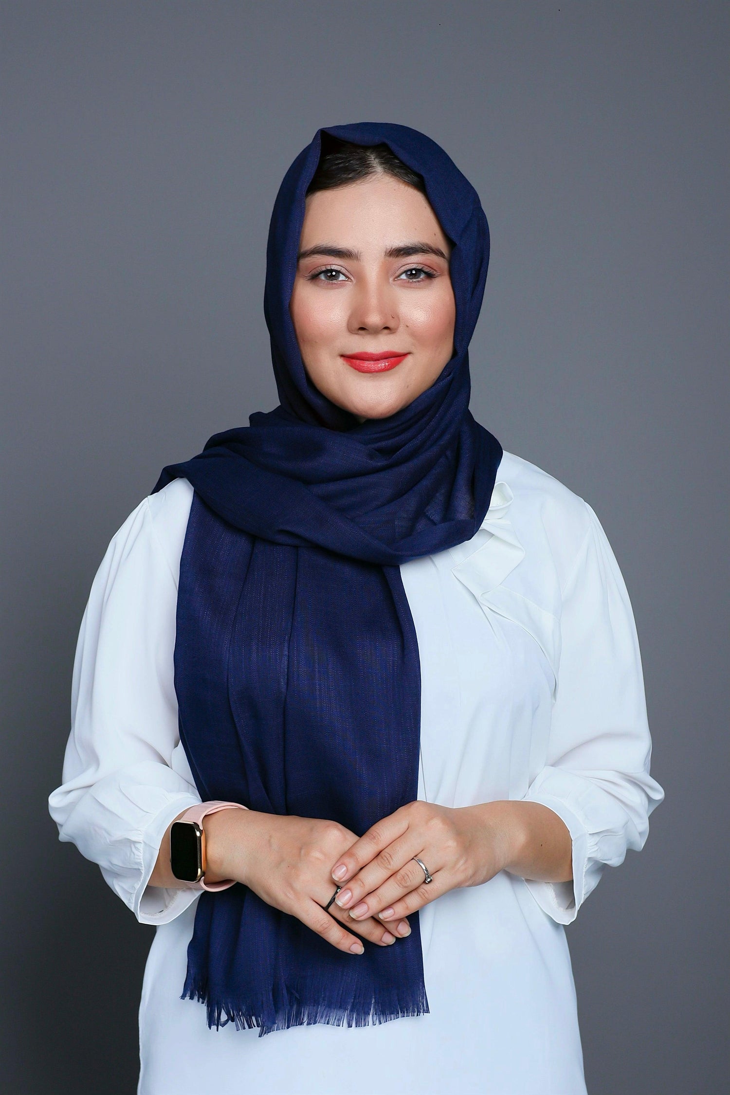 A women wearing Turkish Hijab, viscose fabric, in Black colour, with white top looking her right