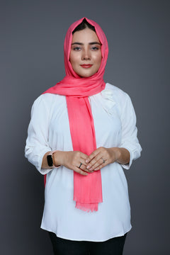 A fashionable hijabi draped in a Peach Quartz Turkish Viscose Hijab, highlighting the hijab's luxurious texture and vibrant color.