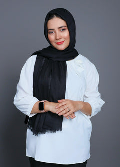 A women wearing Turkish Hijab, viscose fabric, in Black colour, with white top looking her straight