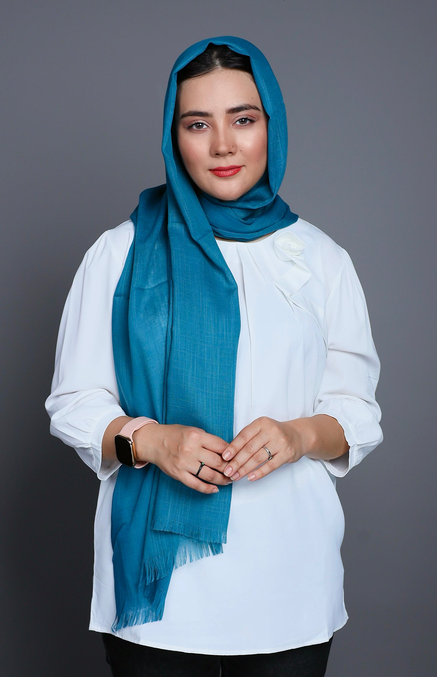 A girl in a soft Cotton and Viscose hijab in Teal Blue, exuding comfort and sophistication while posing outdoors.