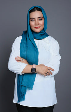 A woman wearing a Teal Blue Turkish Hijab, showcasing elegance and style against a neutral background. Viscose Cotton Fabric.