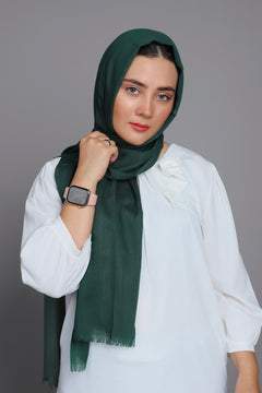 Girl wearing Turkish Hijab, viscose fabric, in bottle green color, with white top.