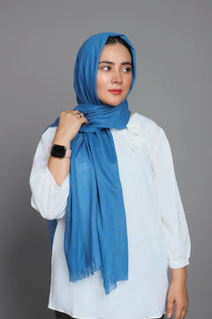 Woman wearing a Lake Blue Turkish Hijab, showcasing its soft and luxurious texture. Cotton Viscose Material.