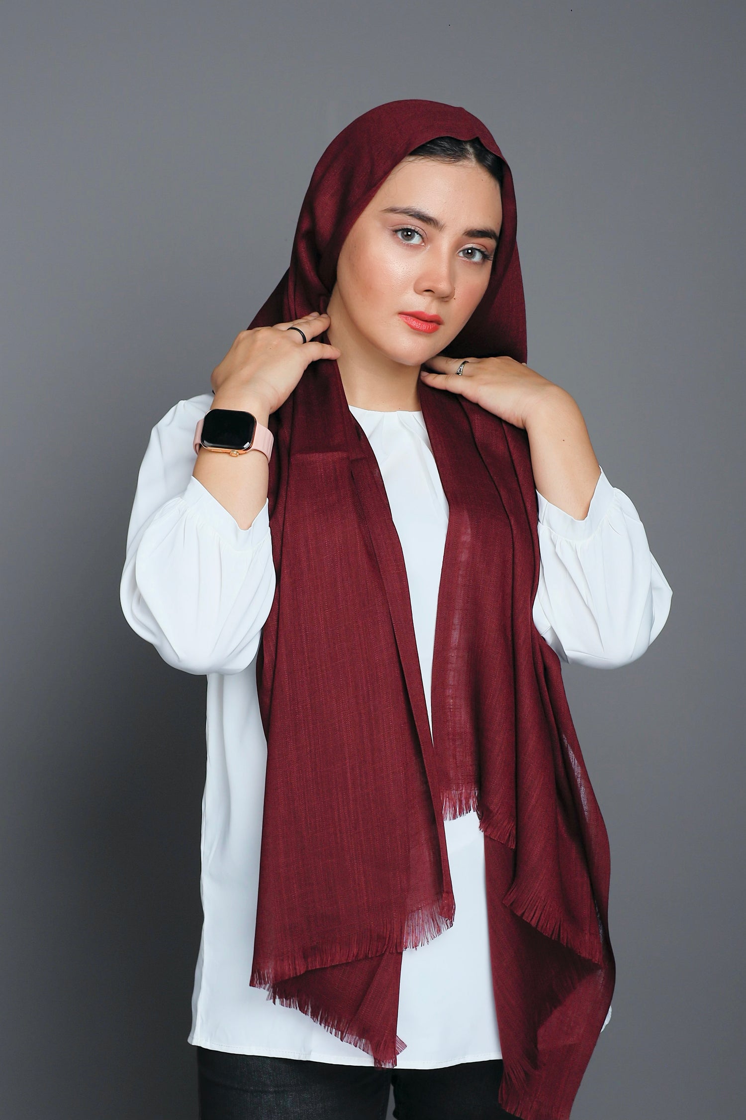 girl wearing Turkish Hijab, viscose fabric, in burgundy colour, on white top looking straight