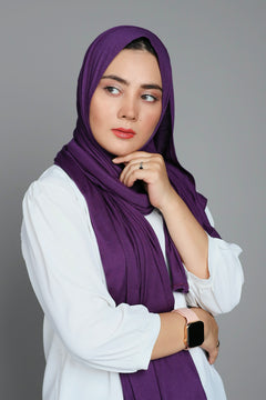 Woman wearing a Violet Jersey Hijab Looking her right.