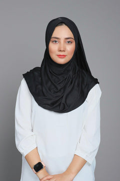 Black Jersey Hijab. Girl wearing it over a white top.