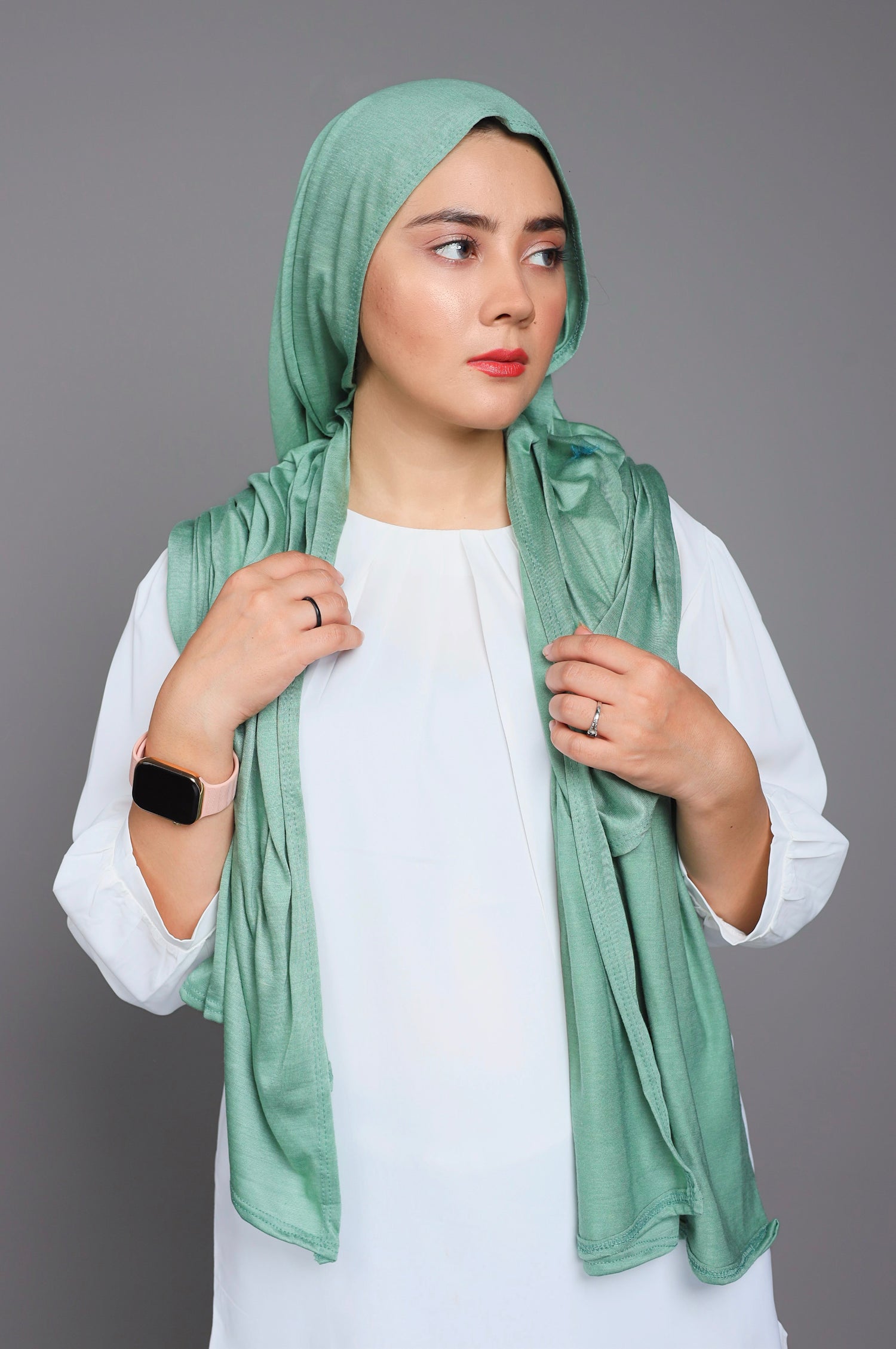 Elegant woman styling in Green Jersey Hijab, perfect for casual and special events.