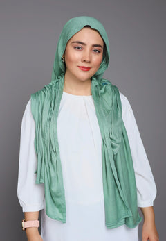 Girl wearing a Jersey Hijab in Green, Showcasing elegance and style.