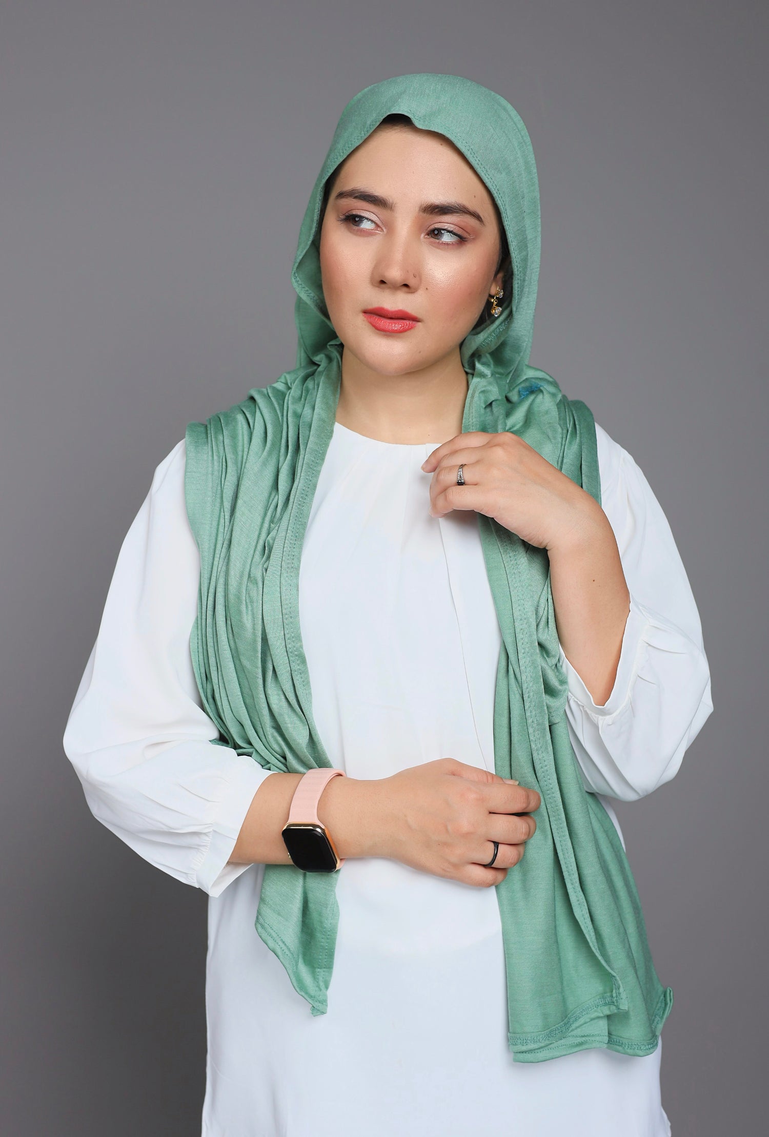 Stylish woman in a Green Jersey Hijab, embracing comfort and fashion.