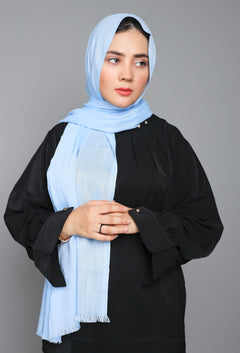 Woman styling a Baby Blue Viscose Hijab, capturing its chic look and lightweight comfort.