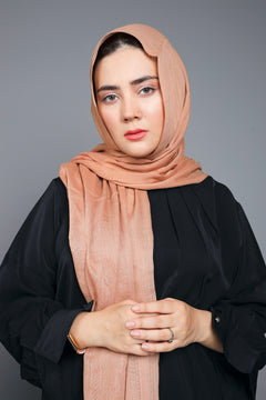 Model showing the versatile styling of a Hazelnut Cotton Viscose Hijab, draped casually around the neck.