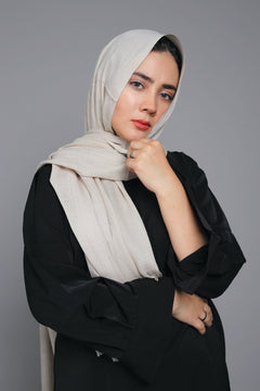 Girl wearing Turkish Hijab, viscose fabric, in honey glaze, with white top looking straight.