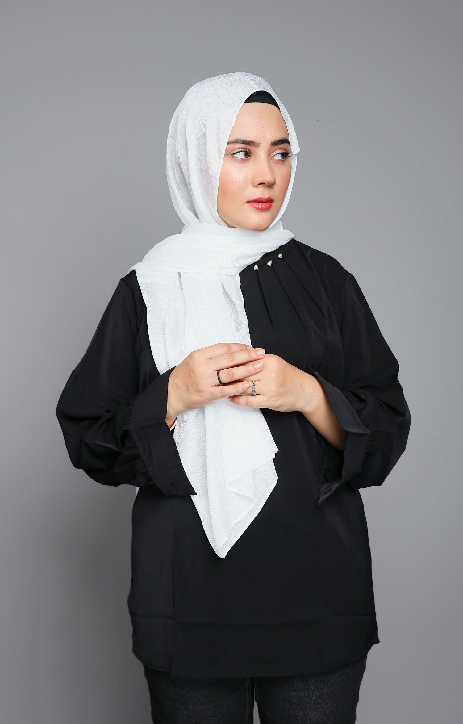 Modern Hijabi wearing pure white chiffon hijab over elegant black top. 