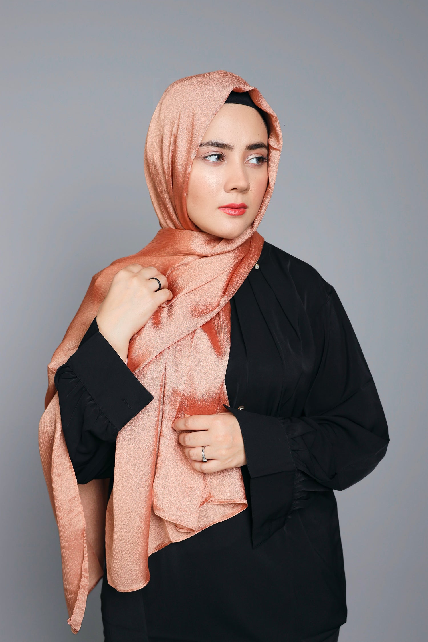 Metallic Chiffon Hijab in copper. Modern Hijabi draping over a black top.