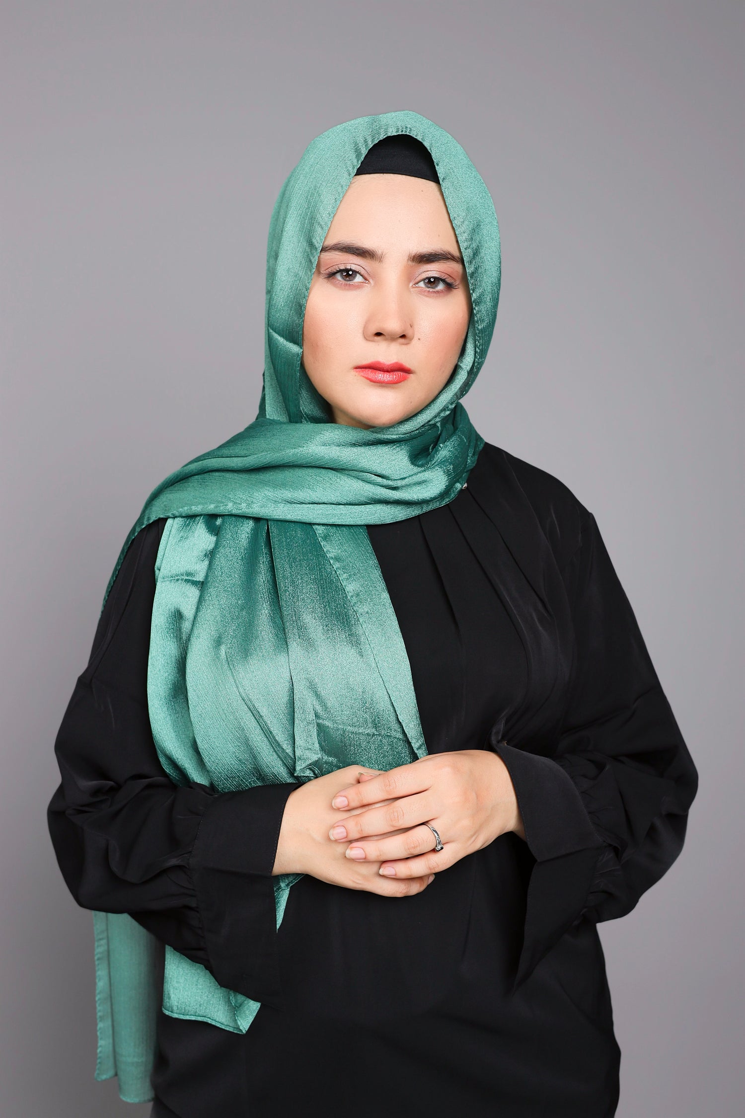 Metallic Chiffon Hijab in peridot  Woman wearing it over black top.