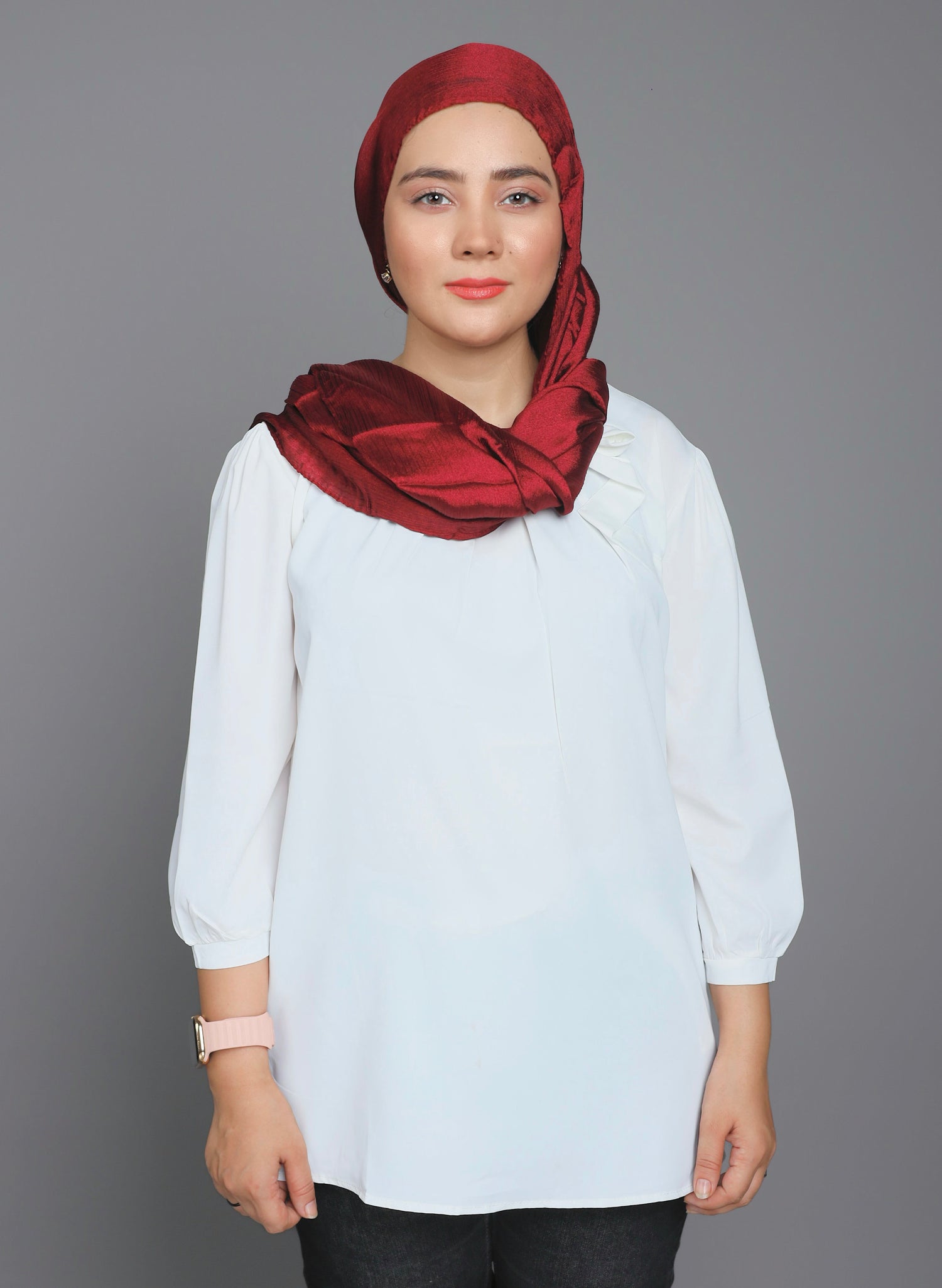 Metallic Chiffon Hijab in Maroon. Woman Styling it over white top.