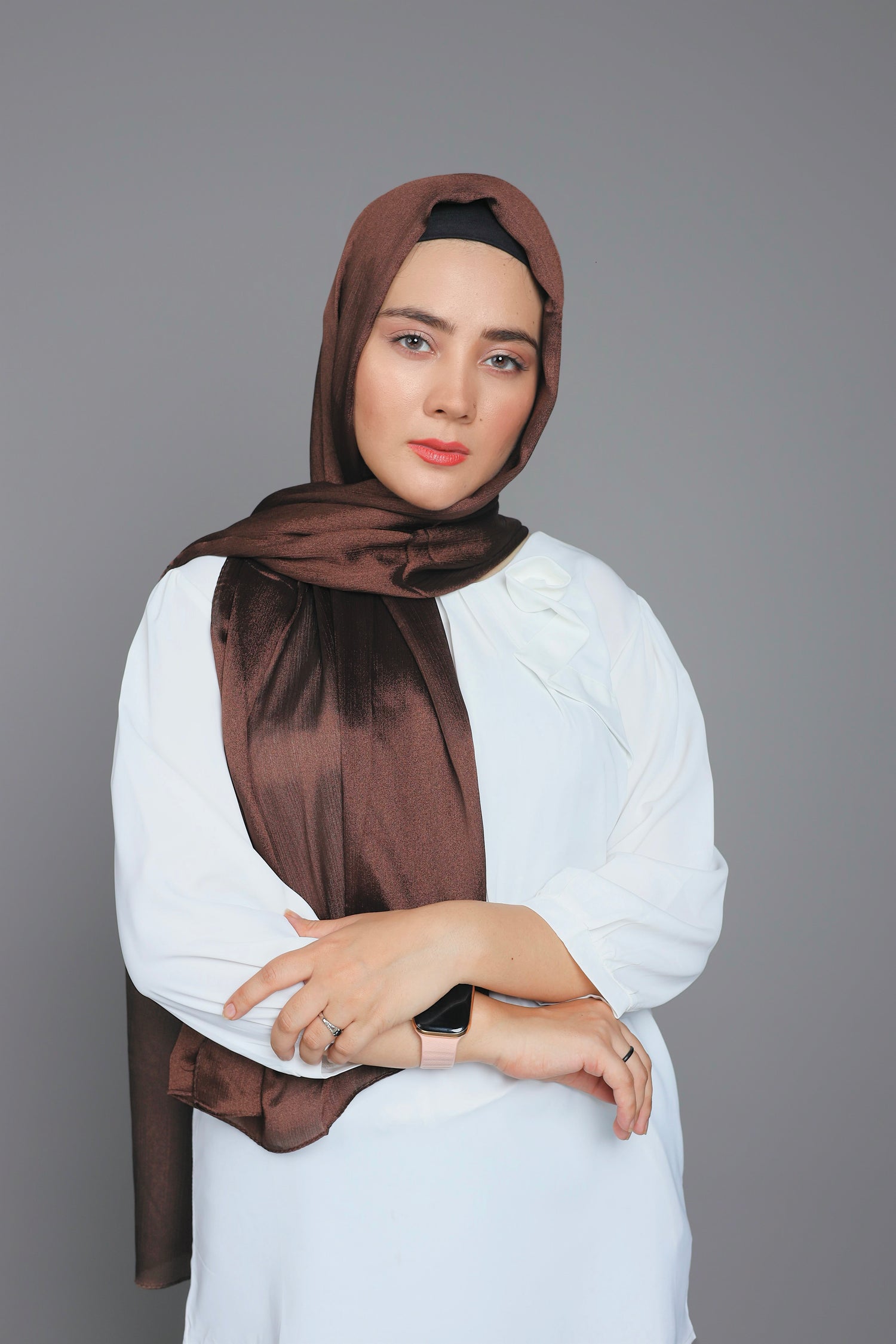 A girl wearing luxurious Metallic Chiffon Hijab in Dark brown shade.