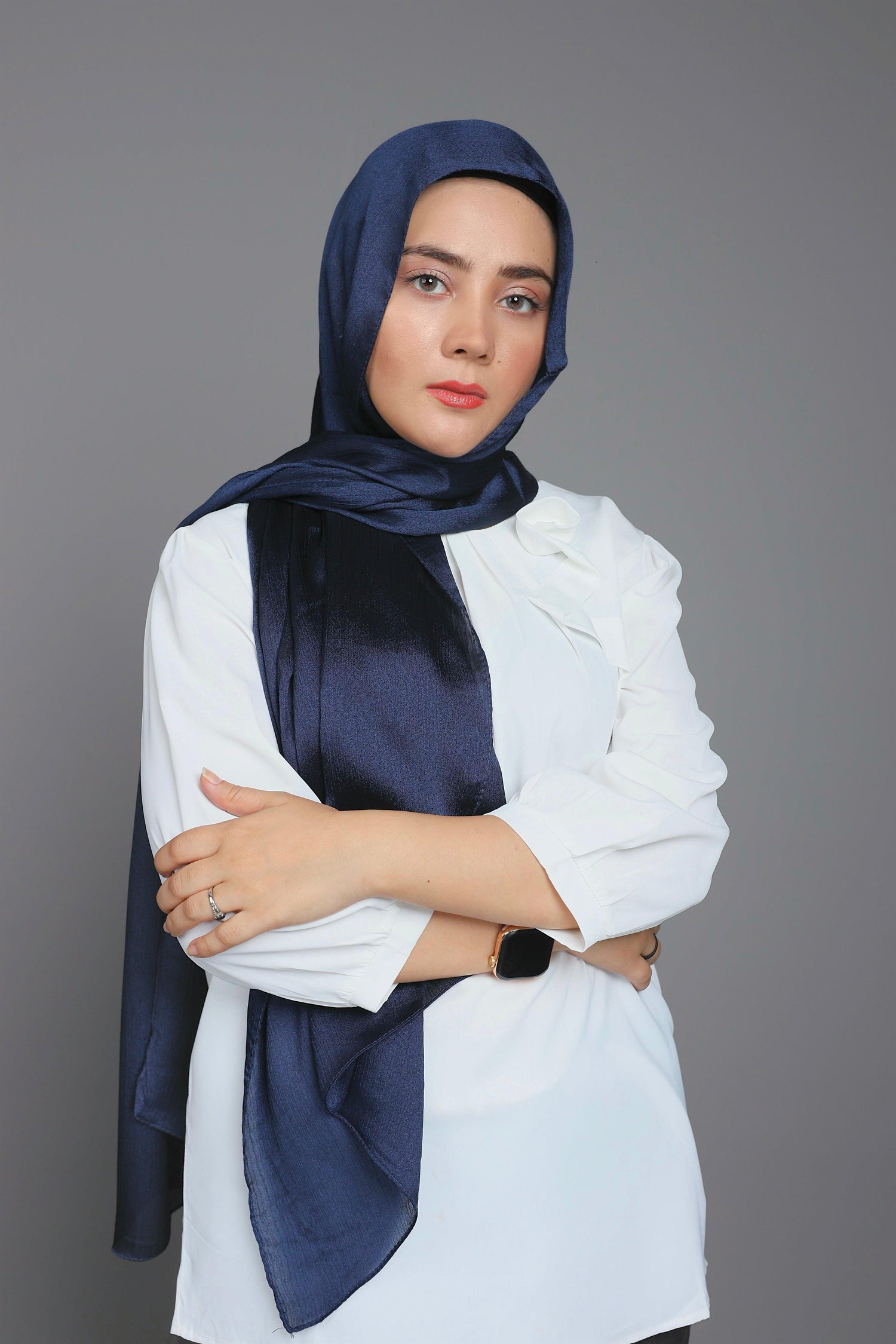 a woman wearing Metallic Chiffon Hijab over a white top. Perfect for any occasion.