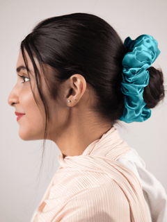 Silk Scrunchie in Sea blue. Woman wearing soft cool hair accessoy.