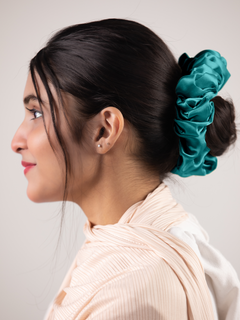 Silk Scrunchie in Turquoise. Woman wears scrunchie a stylish hair accessory. 