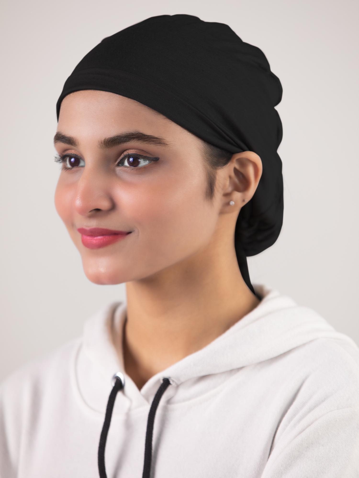 Girl wearing Black Ruched Hijab Cap breathable fabric and elegant ruching.