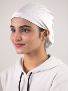 Girl wearing Elegant White Ruched Hijab Cap. Adjustable drawstring.