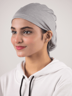 Stylish hijabi wearing Grey Ruched Hijab Cap, offer adjustable fit.