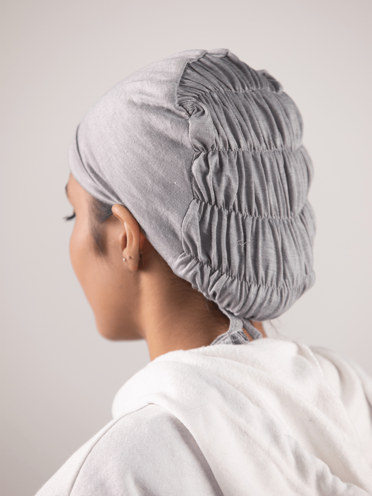 Girl wearing Grey Ruched Hijab Cap with soft, breathable jersey fabric.