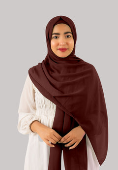 A woman wears a Nutella instant hijab with cap, featuring soft and lightweight georgette fabric. The hijab drapes beautifully, offering premium quality, and versatile styling.