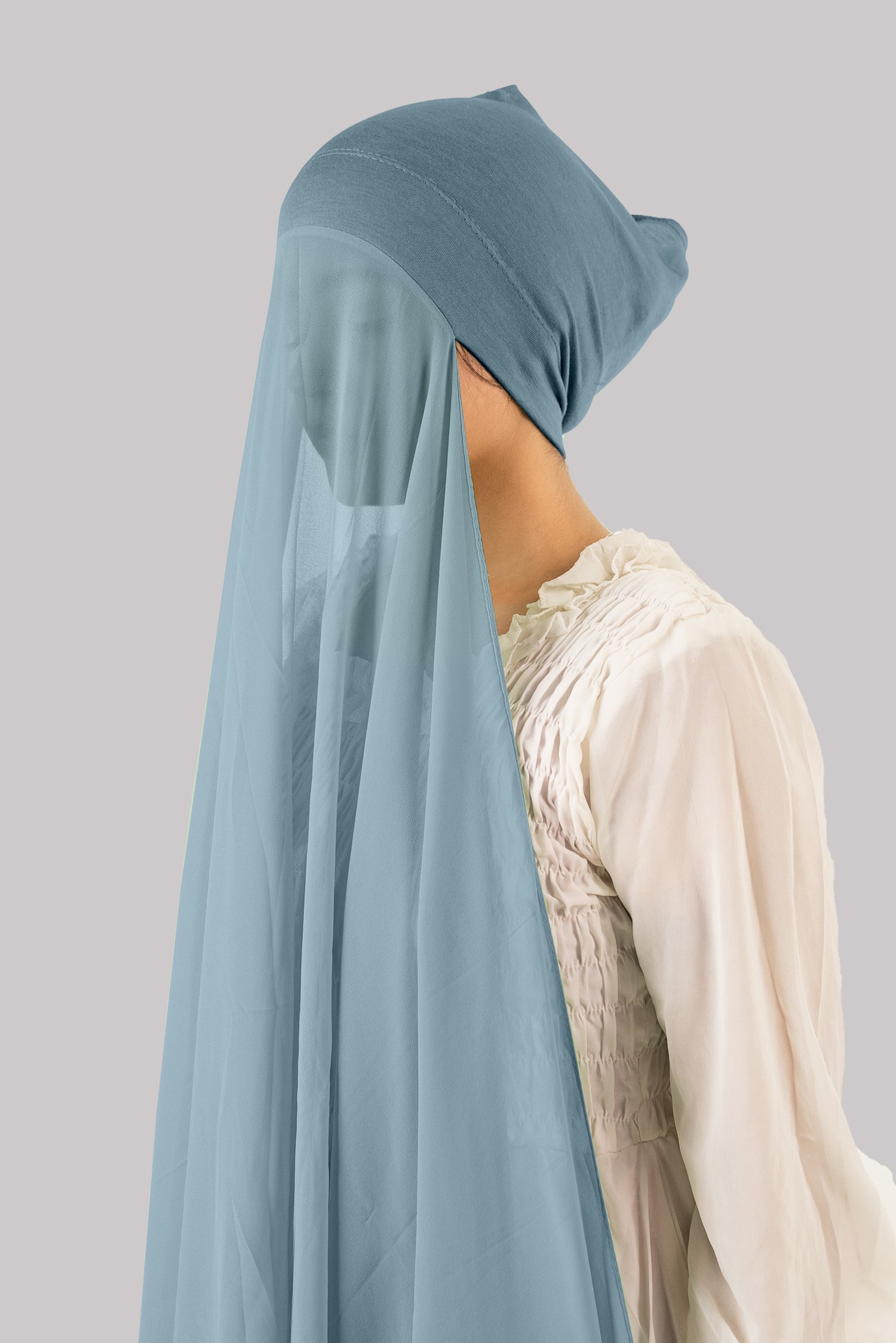 Woman styling in a Sapphire Georgette Instant Hijab with Cap, featuring lightweight and breathable fabric