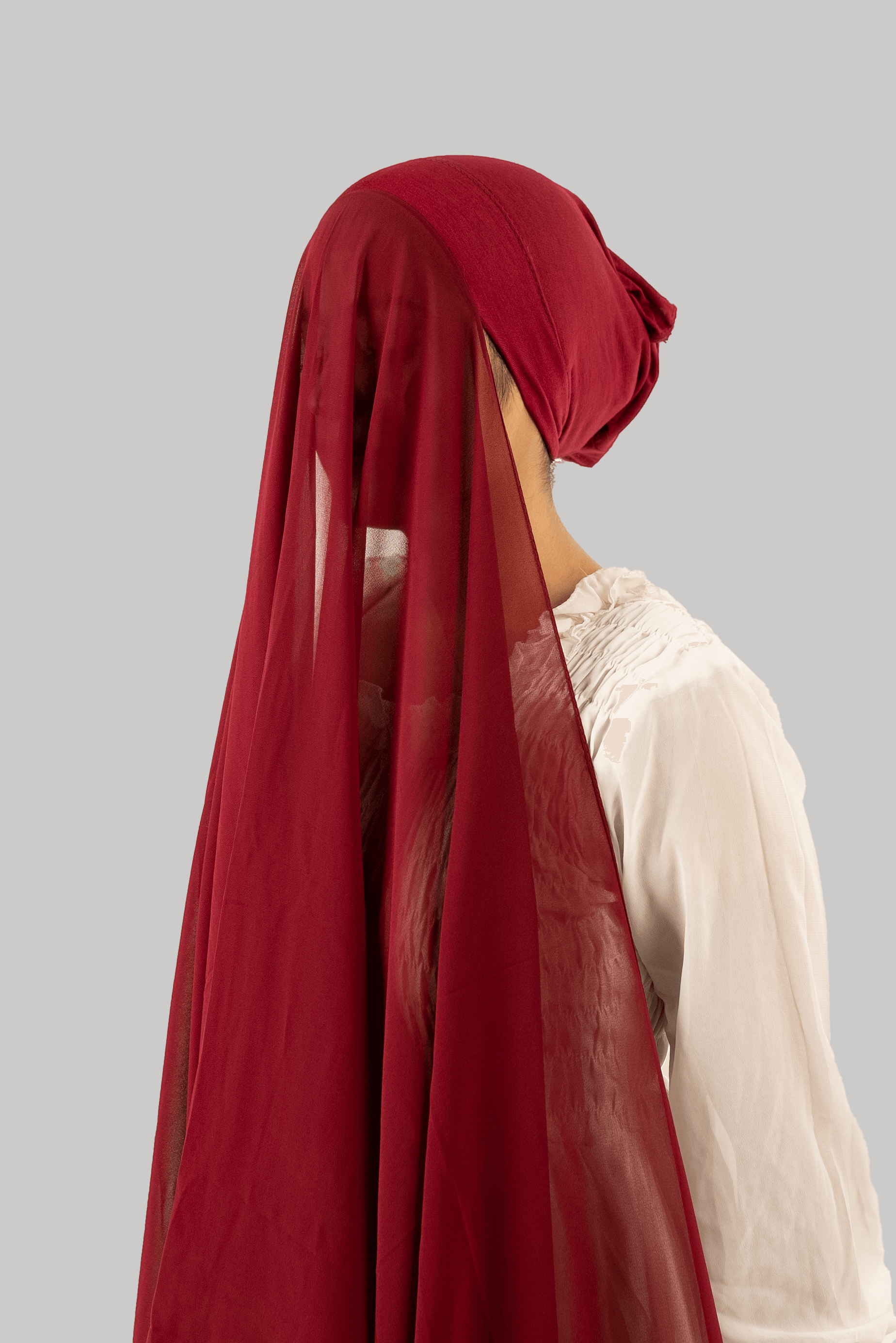 a women wearing georgette instant hijab with tube cap attached in maroon. side profile 