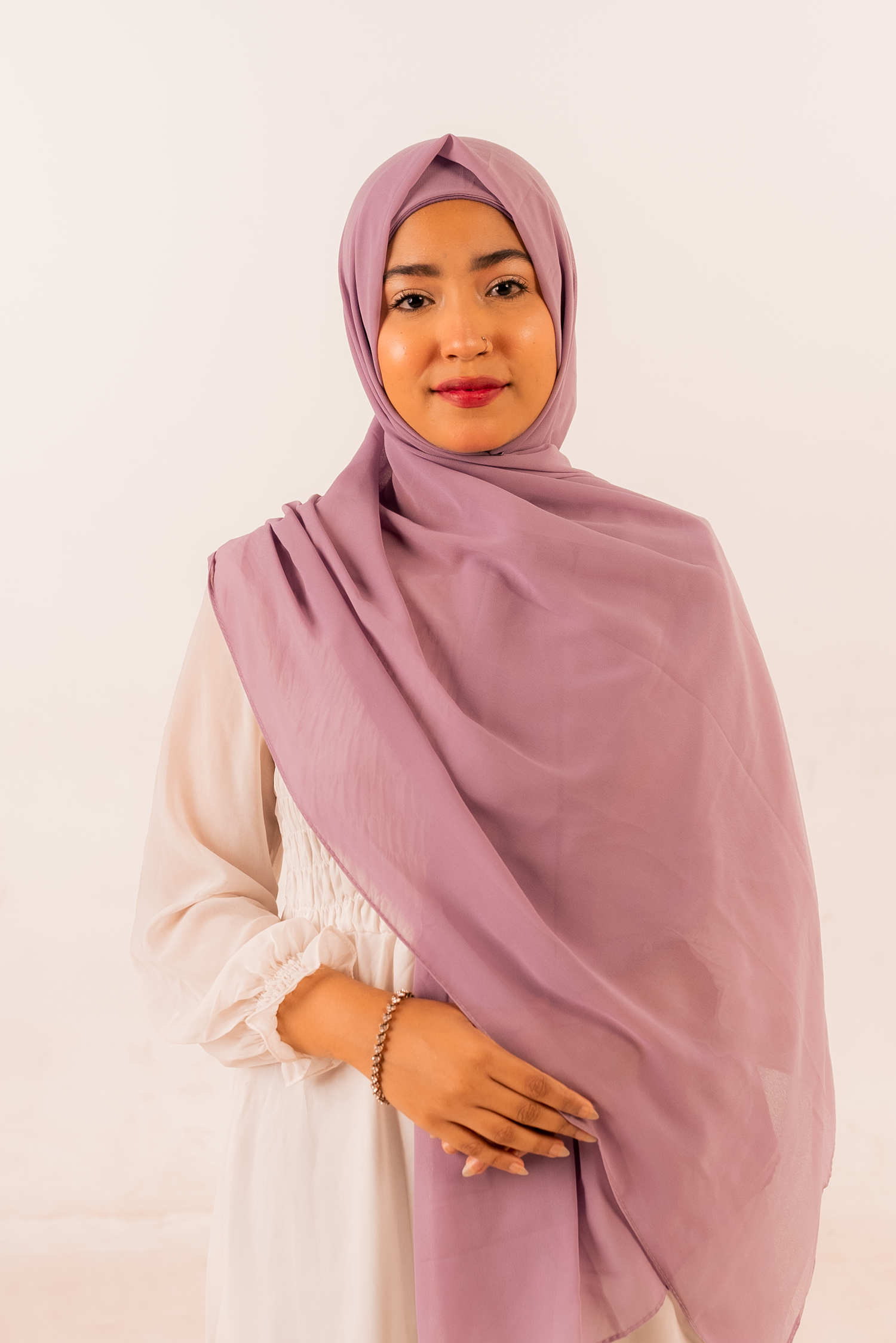 periwinkle georgette instant hijab with cap drapes beautifully on a woman looking her front.