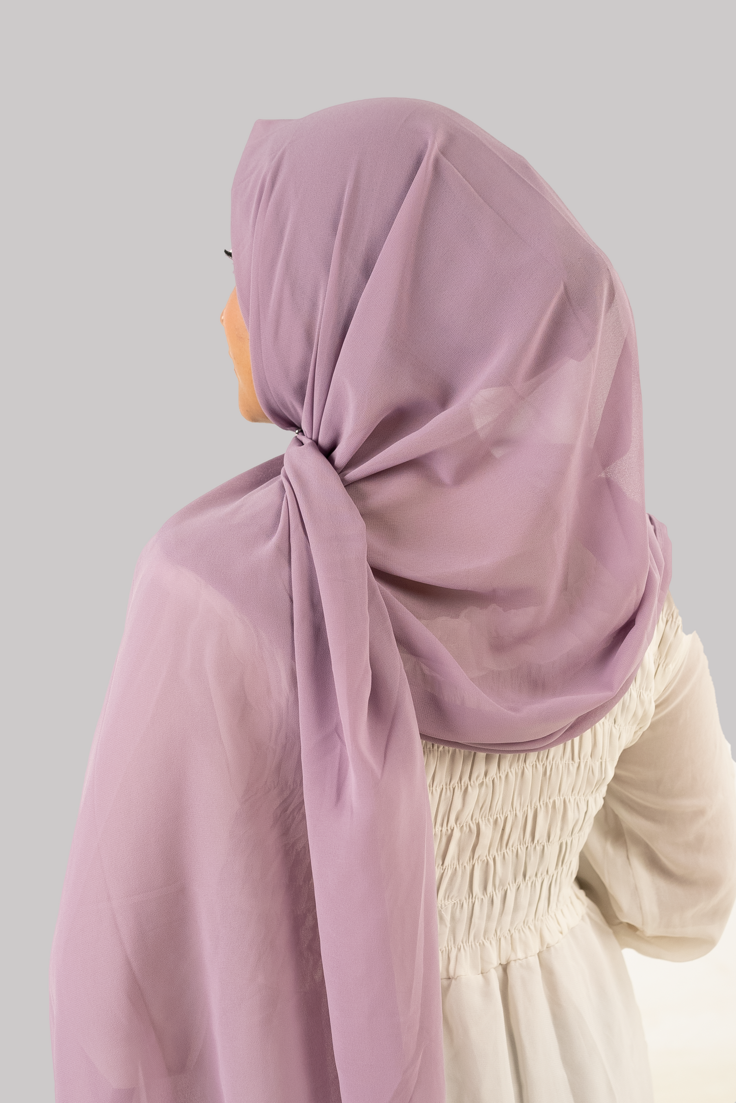 Girl wearing instant hijab with cap in mauve. Georgette material back side.