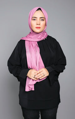 Chic woman wearing a Dark Mauve Jersey Hijab looking straight.