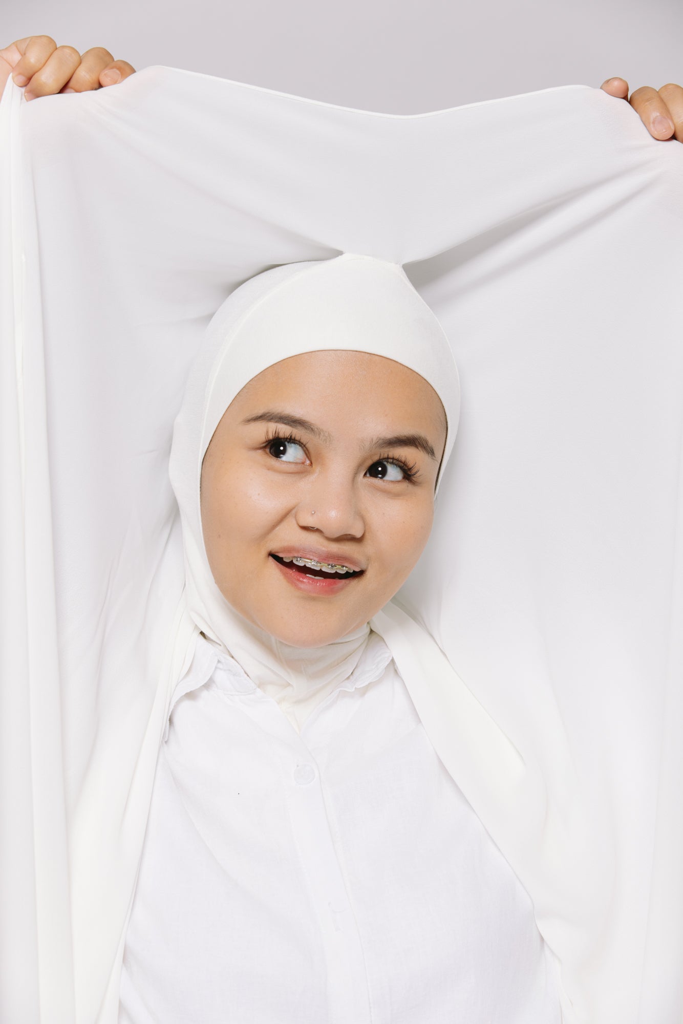 a girl wearing an instant hijab with a ninja cap in white shade.