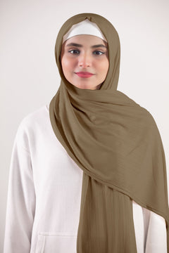 Ribbed Jersey Hijab in Almond. Woman wearing a sophisticated and chic hijab made of ribbed jersey material.