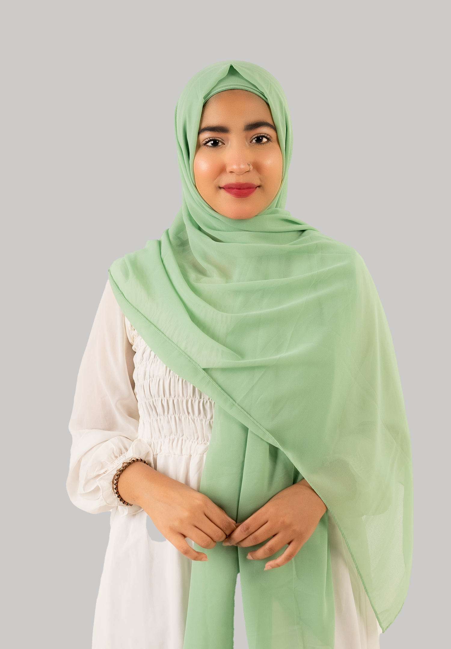 A stylish pistachio georgette instant hijab with cap woman styling looking front side. 