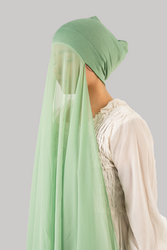 a women wearing instant hijab with cap in pistachio color georgette material side profile