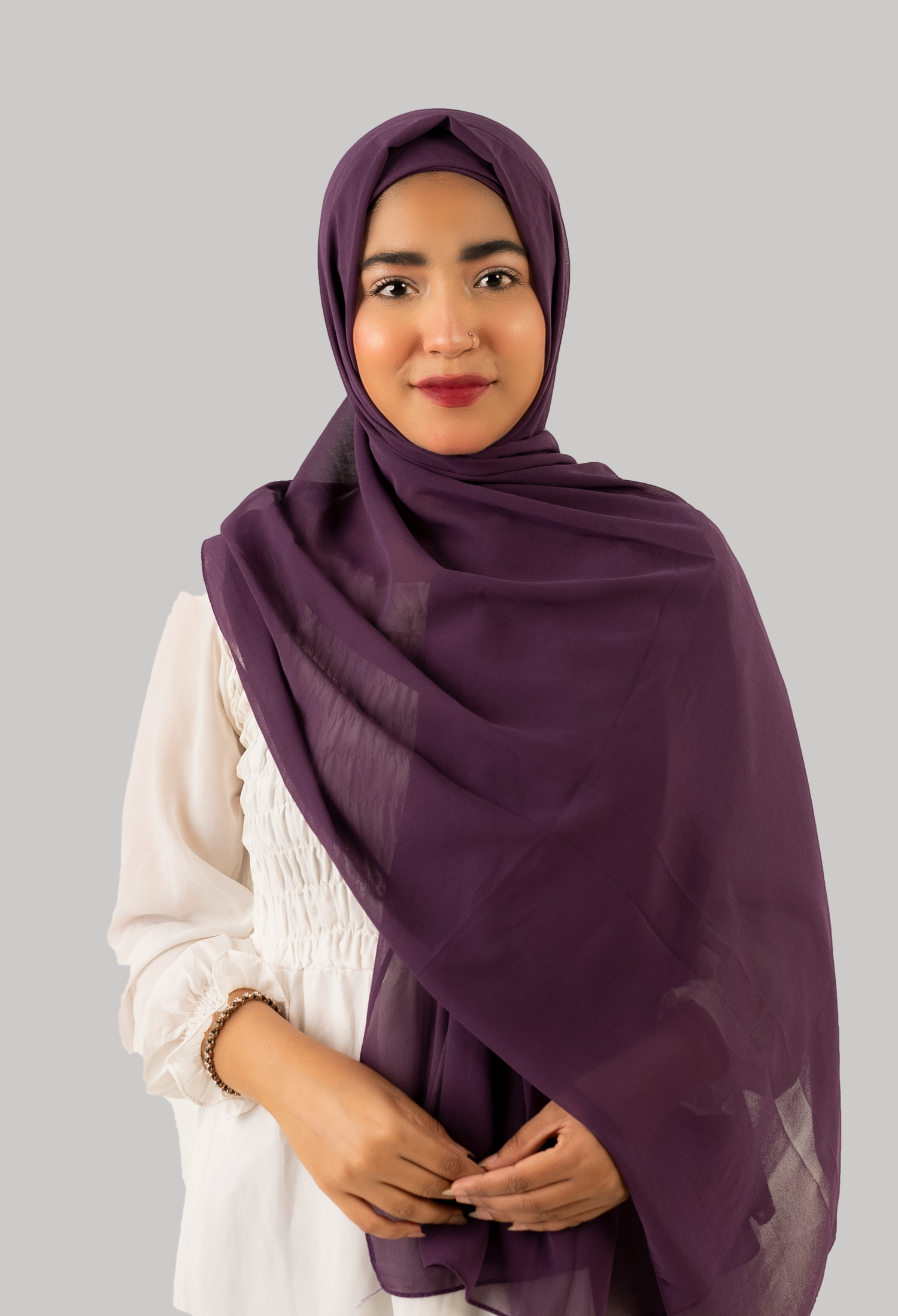 a women wearing instant hijab with cap in purple color georgette material front side