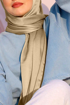 woman wearing satin silk hijab. sand color.