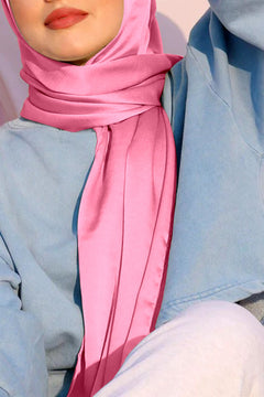 satin silk hijab in pink color. Stylish girl wearing hijab crafted from satin silk.