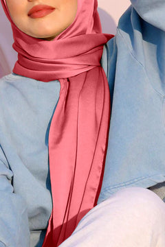 A woman wearing satin silk hijab. rose pink color.