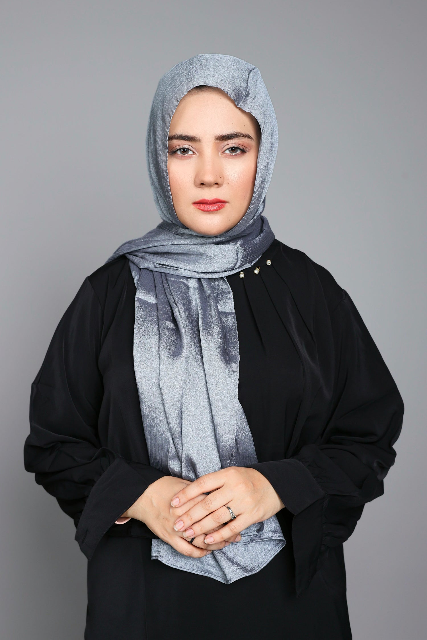 Modern Hijabi wearing Metallic Chiffon Hijab in Classic Silver over black top.