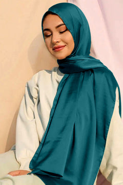 a woman wearing Satin Silk Hijab. Teal Color.