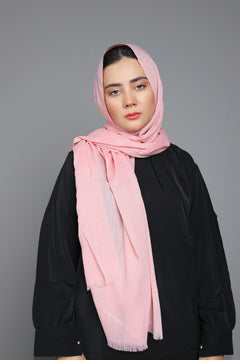 Woman wearing a Vintage Pink Hijab, styled gracefully around the head, highlighting its non-slippery feature.